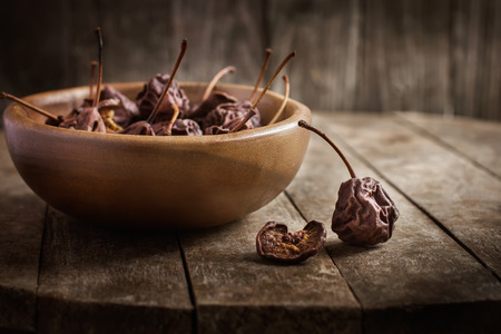 dried pears on a old dark wooden backgroundの写真素材