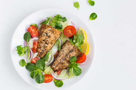 roasted mackerel fish with fresh salad, white background, top viewの写真素材