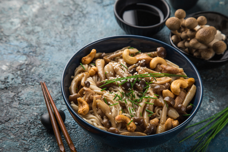 noodles with chicken and shimeji mushrooms in blue  bowl, selective focusの写真素材