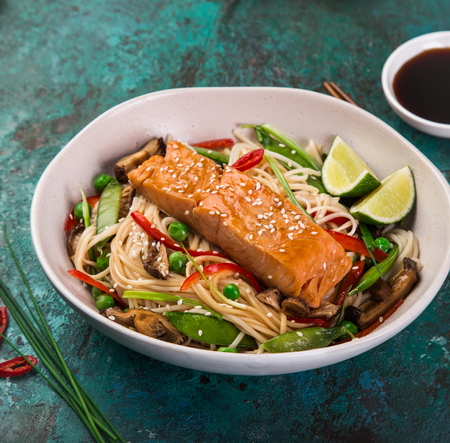 salmon with noodles and vegetables in asian style , selective focus, square imageの写真素材