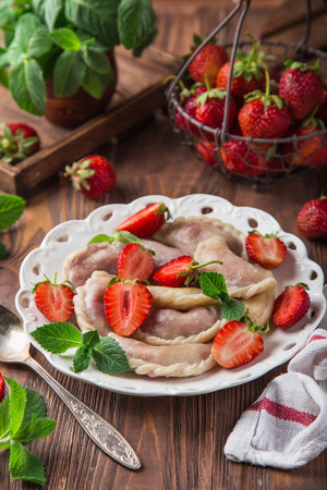 dumplings with strawberry (Vareniki, pierogi), rustic background, selective focusの写真素材