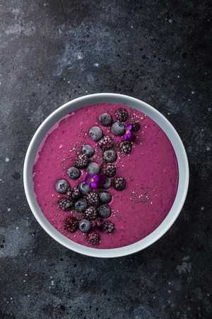 delicious blueberry smoothie bowl with frozen berries. Healthy vegan raw food. top viewの写真素材