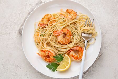 spaghetti pasta with shrimps on white plate, top viewの写真素材