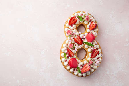 Number 8 naked honey cake for Birthday, pink background, top view, copy space