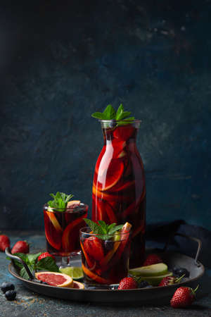 homemade red wine sangria with fruits and berries, selective focus, dark backgroundの写真素材