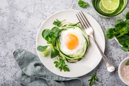 fried egg in zucchini noodle nest, healthy breakfast, top viewの写真素材