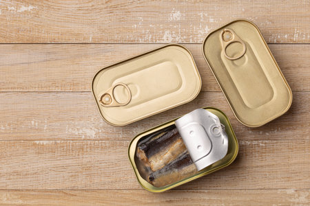 tinned fish, canned sardines preserves. wooden background, top view, copy spaceの写真素材