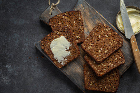 homemade dark rye bread with sunflower seeds, dark background,  top viewの写真素材