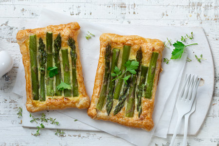 asparagus puff pastry tarts, asparagus baking idea, white wooden backround, top viewの写真素材