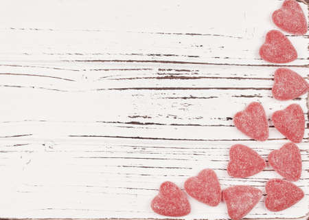 Read heart shape candies on the white wood background for Valentine Day with a spaceのeditorial素材