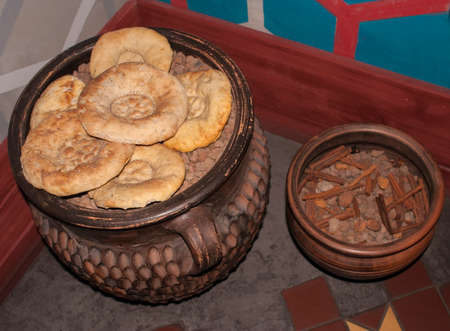 delicious oriental pastries, cinnamon and spices in the big brown potの写真素材