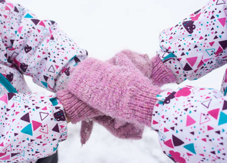 Mittens in snow. Twins at the winter walkの写真素材