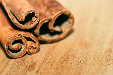 Sticks of fragrant cinnamon on wooden table close-up