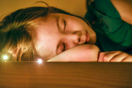 The magic dream of a little girl in her wooden bedの写真素材