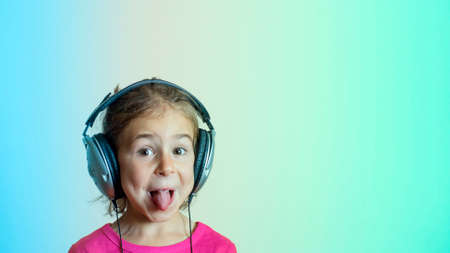 Girl in big headphones listening to musicの写真素材