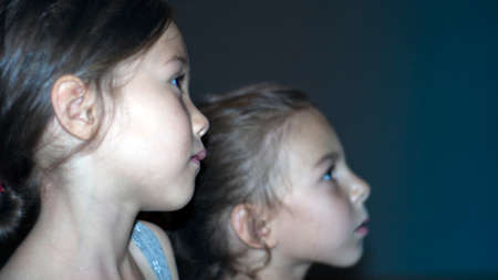 Girls with interest of watching a movie in the cinemaの写真素材