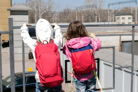 Children with a backpack on their shoulders are going on a trip. Train Station. Traveling with children.の写真素材