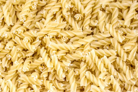 A background of dry pasta in the form of spiralsの写真素材