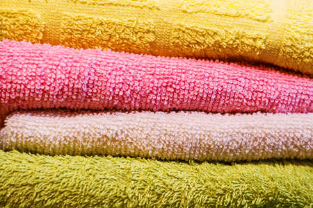 Multicolored towels, folded horizontally on each otherの写真素材