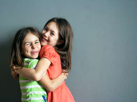 Strong embraces of two happy children. Meeting the sistersの写真素材