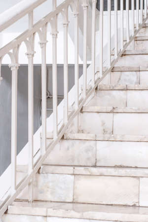 Beautiful Marble staircase with white railing leading upwardsの写真素材