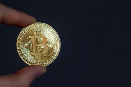 Bitcoin in the person's hand. Electronic money, digital currencyの写真素材