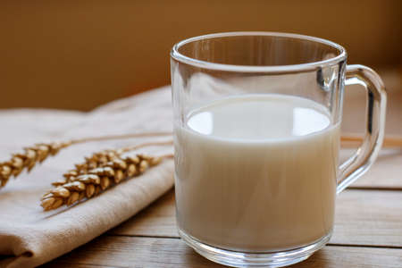 a glass of fresh milk on the wooden tableの写真素材