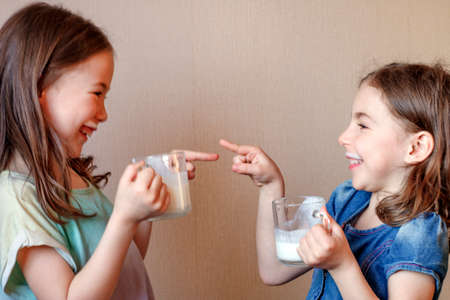 two funny little girls with white mustache from milkの写真素材