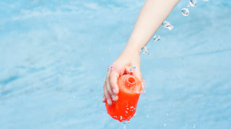 child playing with water in a fountainの写真素材
