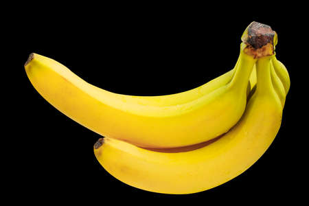 A bunch of ripe yellow banana isolated on a black backgroundの写真素材