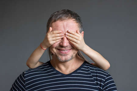 daughter arranged a surprise for his father, closing his eyesの写真素材