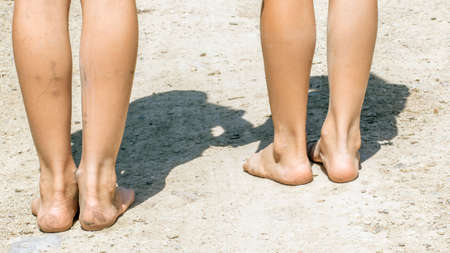 Barefoot children on a country road. Vacation in the villageの写真素材