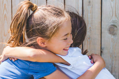 Tender sincere hugs of sisters. Family relationships.の写真素材