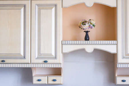 Details of a classic interior in provence style. The kitchen is in warm, gentle light colors.の写真素材