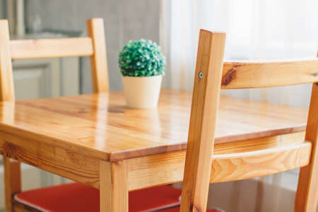 Details of a classic interior. Wooden dining area. Scandinavian style cuisine of the apartment in warm colorsの写真素材