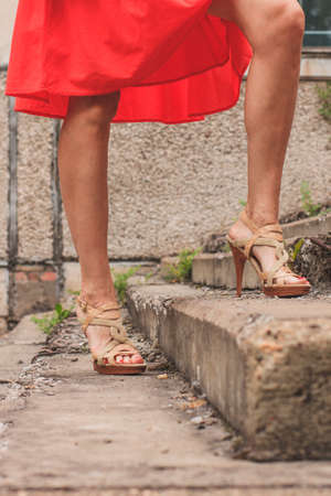 Beautiful girl in a fashionable bright red skirtの写真素材