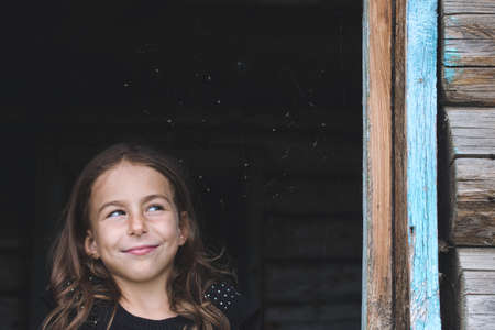 Children spend vacation in the village and playing in wooden house