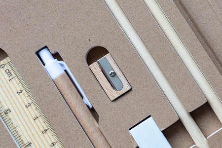 Stationery set of eco-friendly materials. Wooden pencil, sharpener, cardboard pen and eraser.