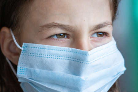Portrait of a girl in a medical maskの写真素材
