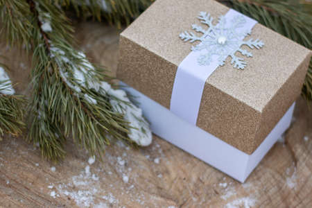 Glitter Gift Box golden color on wooden backgroundの写真素材