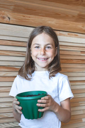 Children planted potted flowers. Home gardenの写真素材