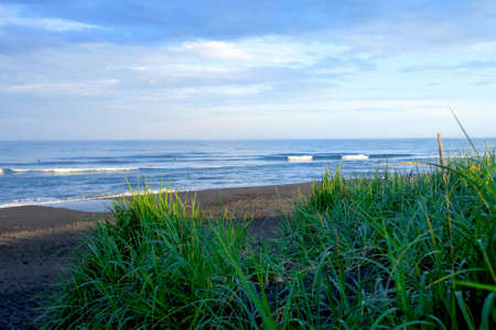 Landscape Pacific ocean with strong waves in Kamchatka with a penetrating bright beam in the skyの写真素材