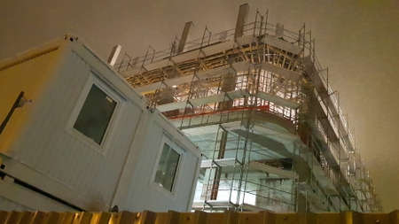 Night work on the construction of new housing for young families. Builders rest. Work on the...