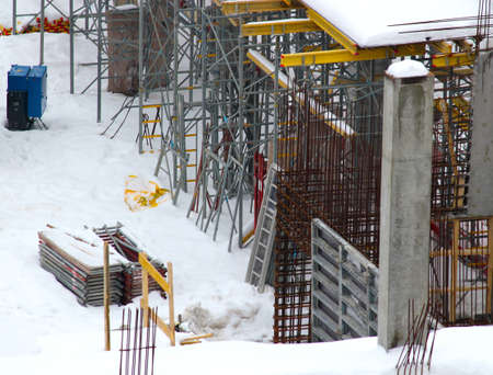 Construction of residential buildings. Scaffolding. Construction works take place in winter. Sale of apartments. Finance.の写真素材