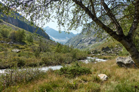 Mountain river landscape. Alps. In the morning in clear sunny day on a wide corner. The river quickly flows. Mountaineering and hikes. Background. Beautiful.の写真素材