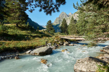 Mountain river landscape. Alps. In the morning in clear sunny day on a wide corner. The river quickly flows. Mountaineering and hikes. Amazing. Around.