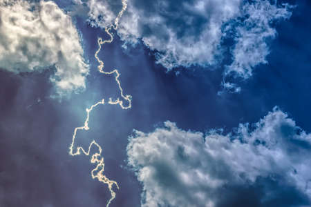 Lightning amid a dark blue sky. Cumulus clouds. A tropical storm warning. trend, wallpaper, zipper, atmosphere, awe, belief, bibleの写真素材
