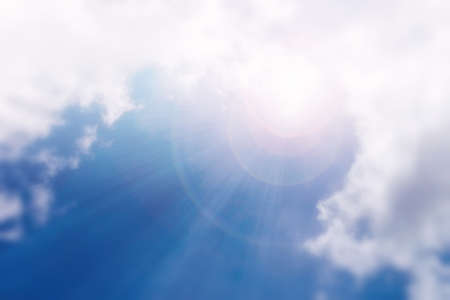 A bright ray of sunshine breaks through the fluffy white clouds. The mysterious light of day....