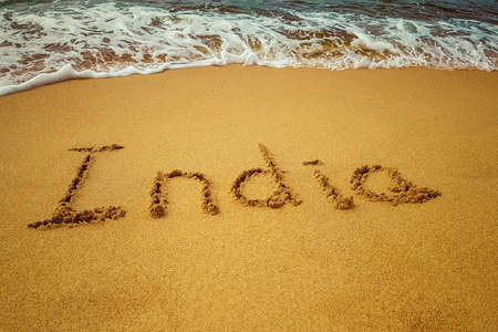 India title on the sand beach of the coast Indian ocean.の写真素材