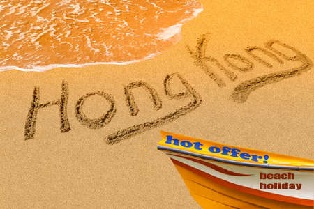 Hong Kong title on the sand beach of the South China sea. The red boat stands on the shore. Rest. Hot offer.の写真素材